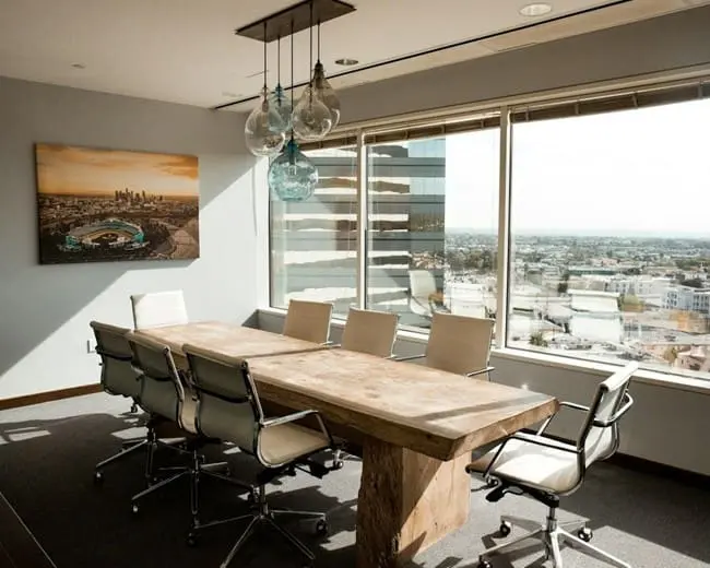 A boardroom table, recently restored with staining and dent removal techniques