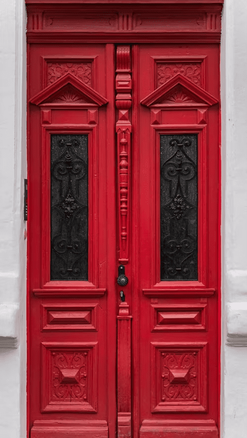 Ornate red door on the exterior of a building.