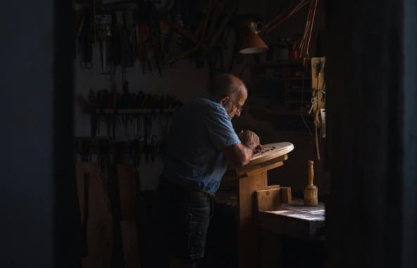 A professional performs restoration services on antique wood pieces